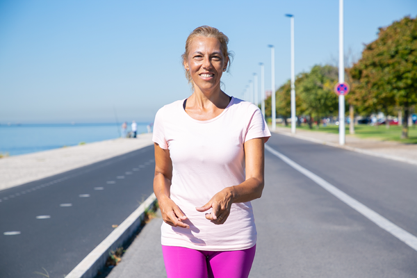 Active woman walking outdoors with improved appetite awareness and healthy lifestyle